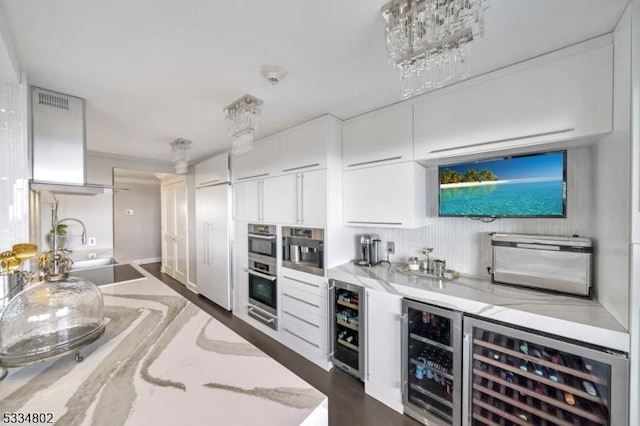 bar with white cabinetry, light stone countertops, sink, and beverage cooler