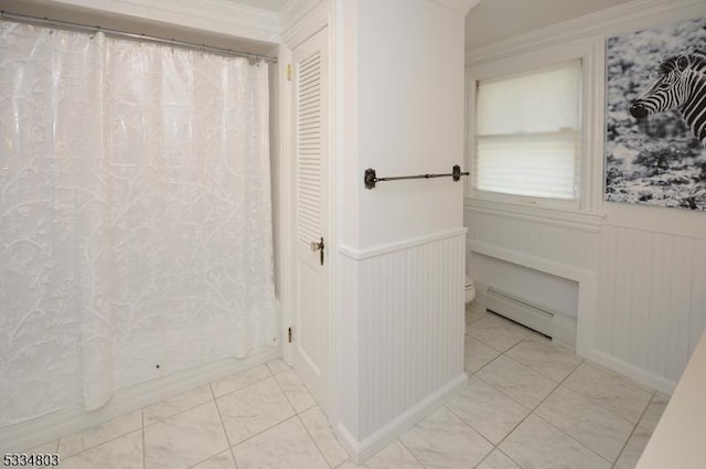 bathroom featuring a baseboard heating unit and toilet