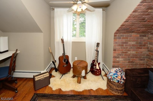 living area with hardwood / wood-style floors, brick wall, ceiling fan, and baseboard heating