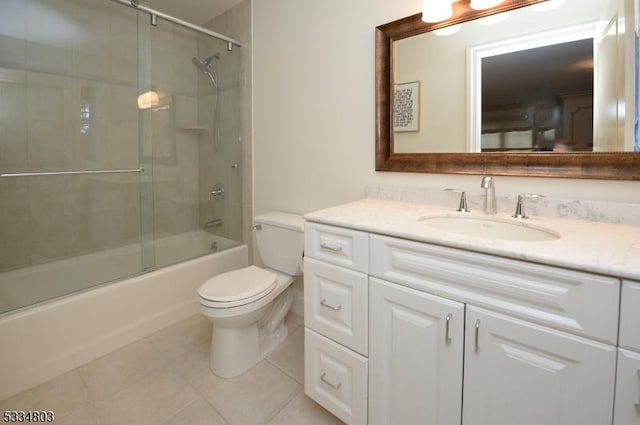 full bathroom featuring tile patterned floors, toilet, combined bath / shower with glass door, and vanity