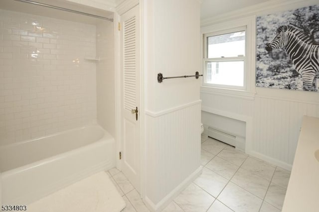 bathroom with toilet, tiled shower / bath combo, and a baseboard heating unit