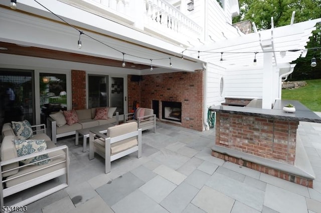 view of patio with an outdoor hangout area and exterior kitchen