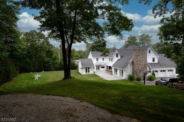 exterior space with a garage and a front lawn