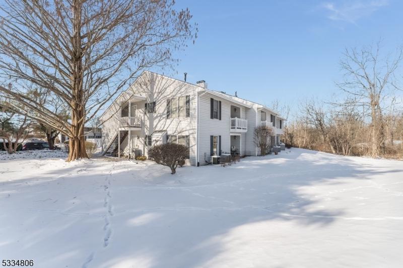 view of snow covered exterior featuring a balcony