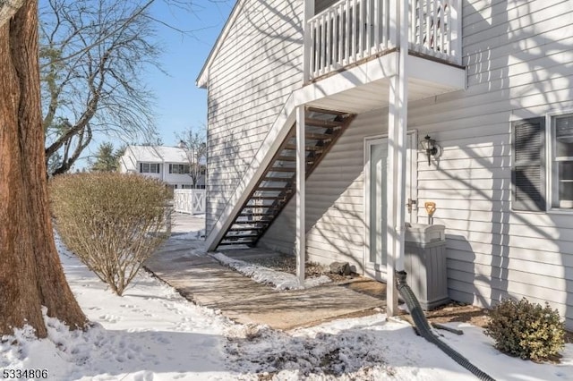 view of snowy exterior featuring a balcony