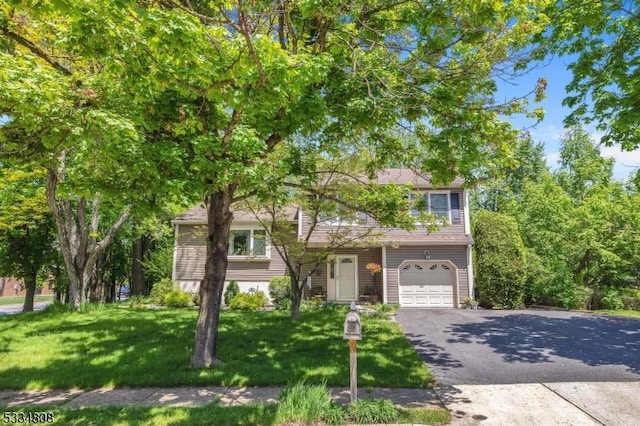 view of front of property with driveway, a front yard, and a garage