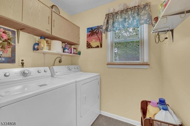 laundry area with separate washer and dryer, cabinet space, and baseboards