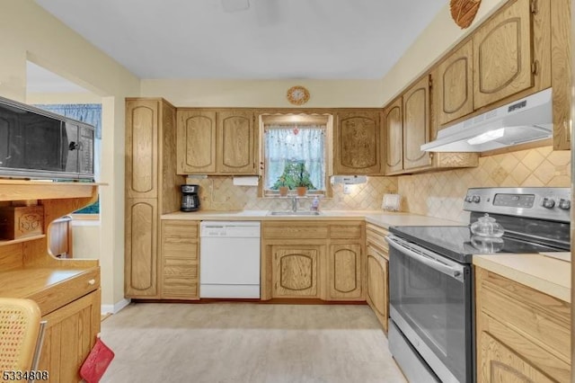 kitchen with stainless steel electric range, white dishwasher, under cabinet range hood, a sink, and tasteful backsplash
