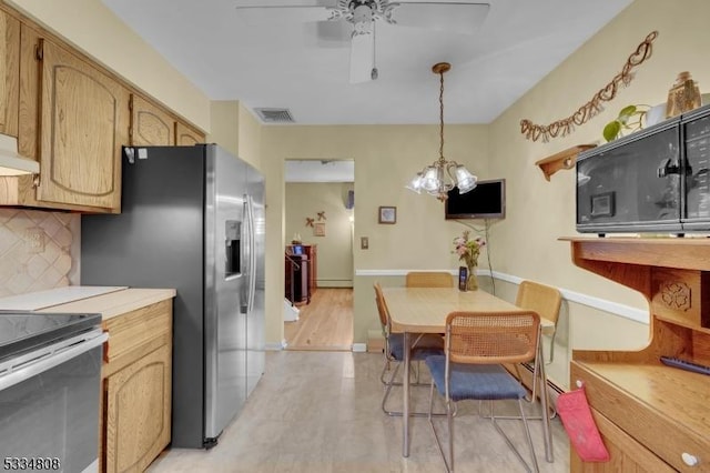 kitchen with stainless steel appliances, ceiling fan, backsplash, light countertops, and decorative light fixtures