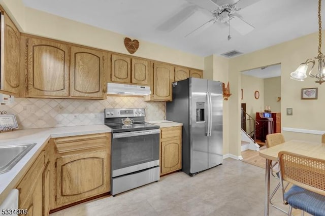 kitchen with stainless steel appliances, under cabinet range hood, decorative backsplash, and a ceiling fan