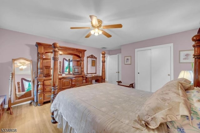 bedroom featuring light wood finished floors, a closet, and ceiling fan
