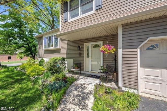 doorway to property with a garage