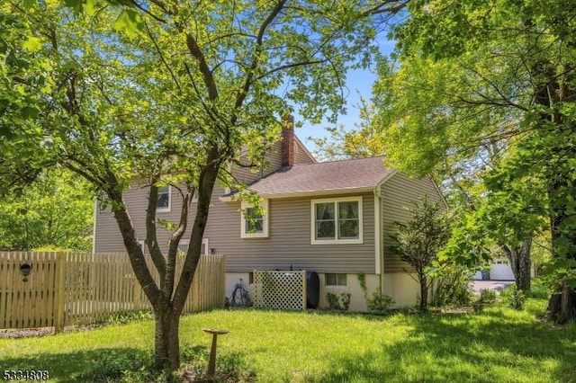 rear view of house featuring a chimney