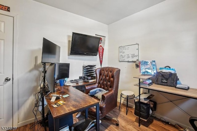 home office with hardwood / wood-style flooring