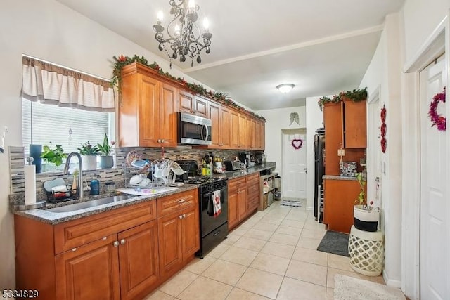 kitchen featuring sink, decorative backsplash, light tile patterned floors, a notable chandelier, and black gas stove