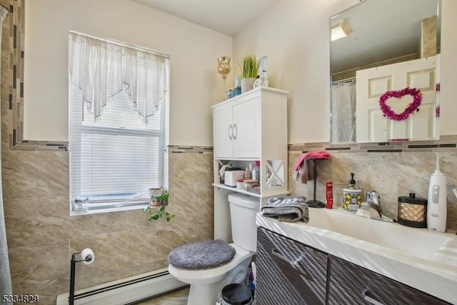 bathroom featuring vanity, tile walls, baseboard heating, and toilet