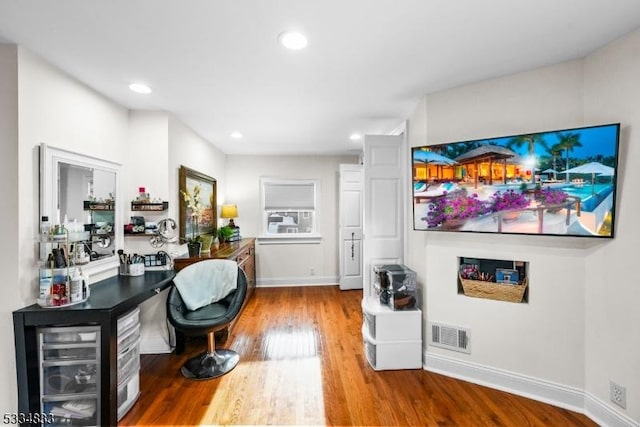 living room with beverage cooler, built in desk, and hardwood / wood-style floors