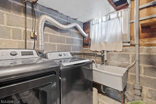 laundry room with independent washer and dryer, tile patterned floors, and sink