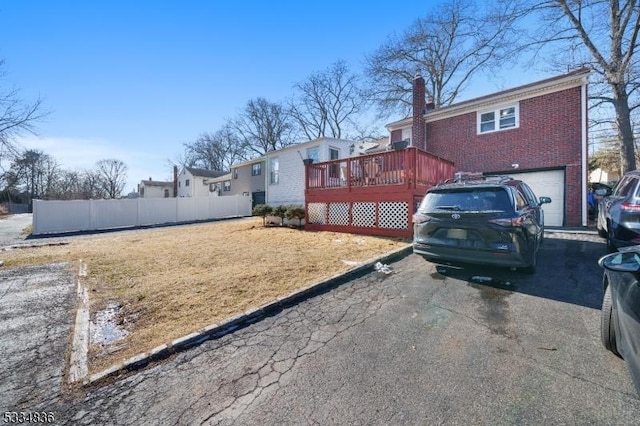 view of yard featuring a garage and a deck