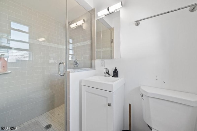 bathroom featuring vanity, toilet, and walk in shower