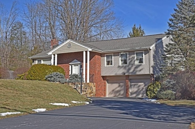 view of front of house featuring a garage and a front lawn