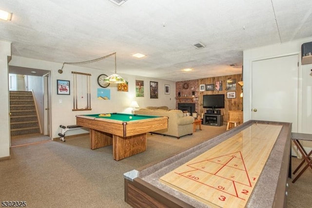 playroom with a brick fireplace, pool table, carpet, and a textured ceiling