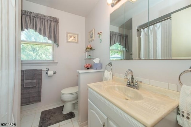 bathroom with vanity, tile patterned floors, and toilet