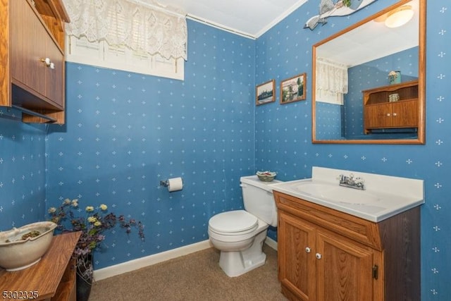 bathroom with vanity, ornamental molding, and toilet