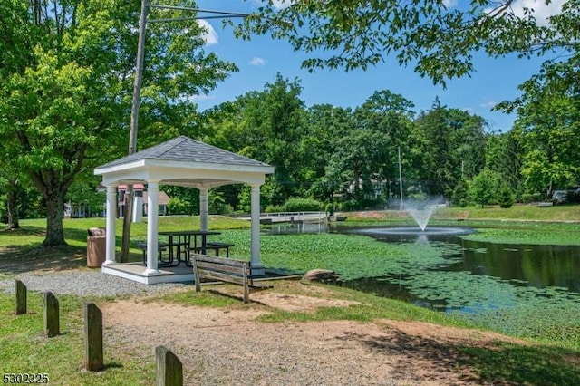 view of property's community featuring a water view, a yard, and a gazebo