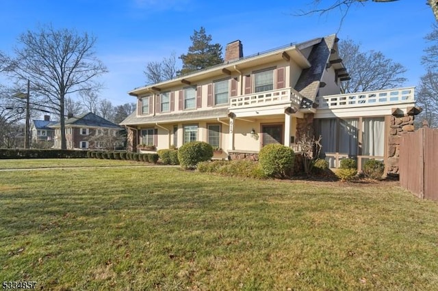 exterior space featuring fence, a lawn, a chimney, and stucco siding