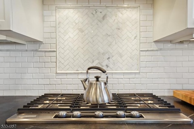 kitchen featuring white cabinets and decorative backsplash