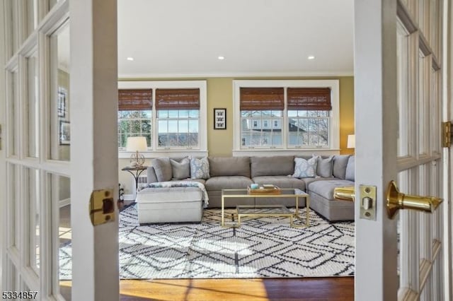 living area with recessed lighting, crown molding, and wood finished floors