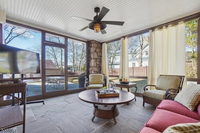 sunroom / solarium with a ceiling fan