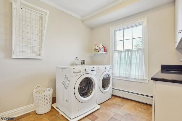 washroom featuring cabinet space, baseboards, crown molding, washing machine and dryer, and a baseboard heating unit