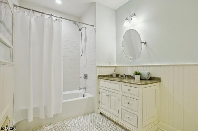 full bathroom with shower / tub combo, wainscoting, vanity, and tile patterned floors