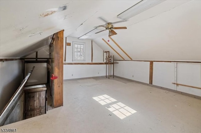 additional living space featuring lofted ceiling and baseboards