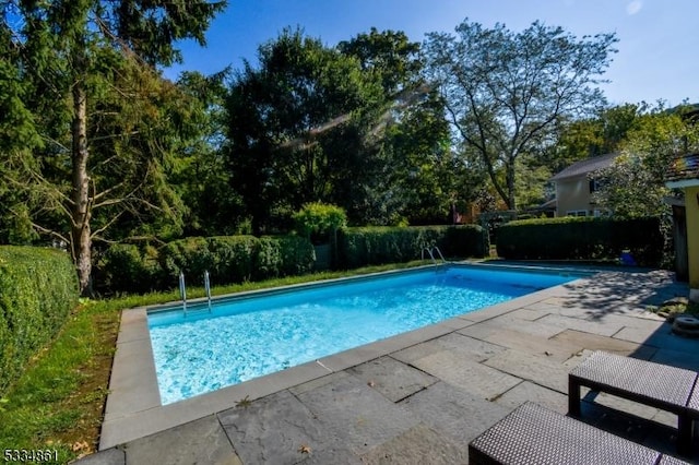 view of pool with a patio and a fenced in pool