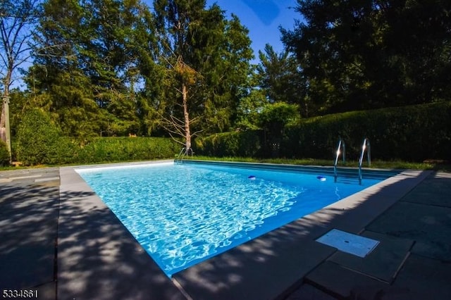 view of swimming pool with a fenced in pool