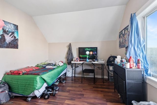 bedroom featuring lofted ceiling and dark hardwood / wood-style flooring