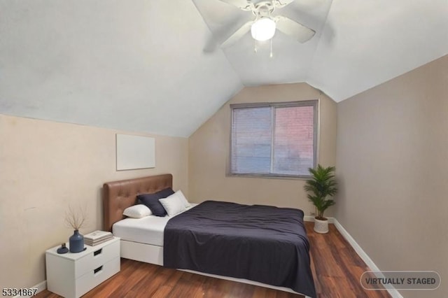 bedroom featuring dark wood-type flooring, ceiling fan, and lofted ceiling