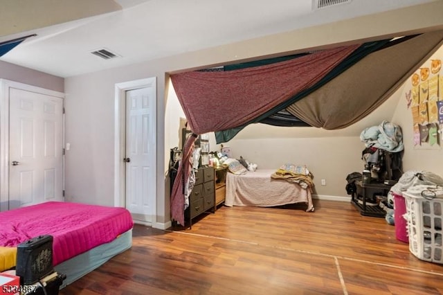 bedroom with hardwood / wood-style floors