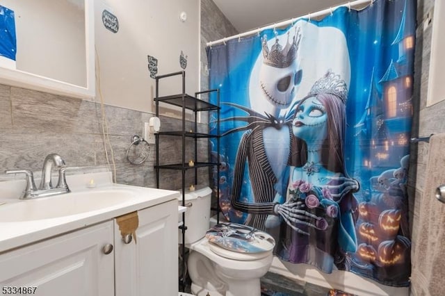 bathroom with tile walls, backsplash, vanity, toilet, and a shower with shower curtain