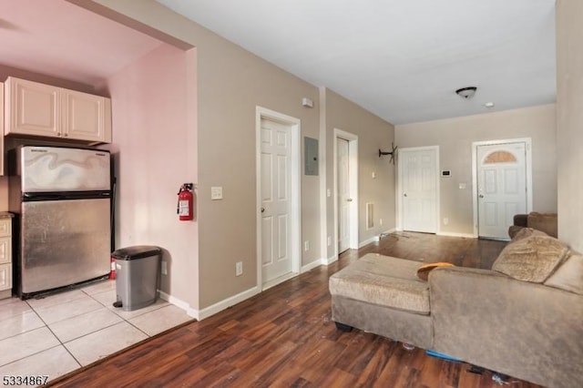 living room with electric panel and light hardwood / wood-style floors