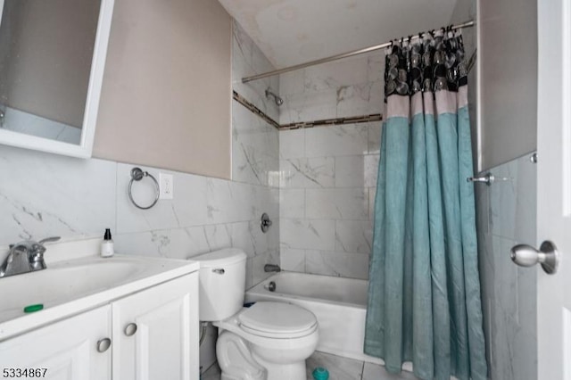 full bathroom with tile walls, vanity, toilet, tile patterned floors, and shower / bath combo with shower curtain