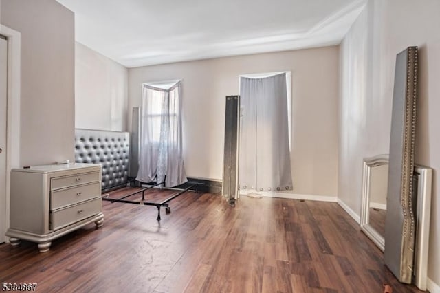 unfurnished bedroom with dark hardwood / wood-style floors