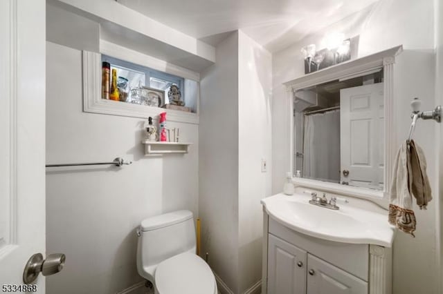 bathroom featuring vanity, toilet, and walk in shower