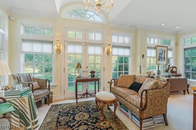 sunroom with french doors, lofted ceiling, and an inviting chandelier