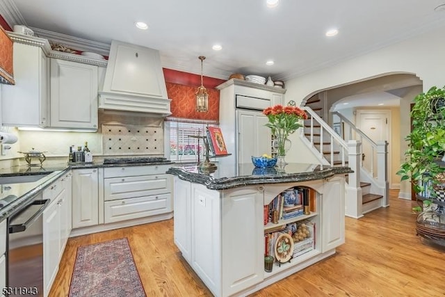 kitchen with pendant lighting, appliances with stainless steel finishes, a center island, white cabinets, and custom exhaust hood