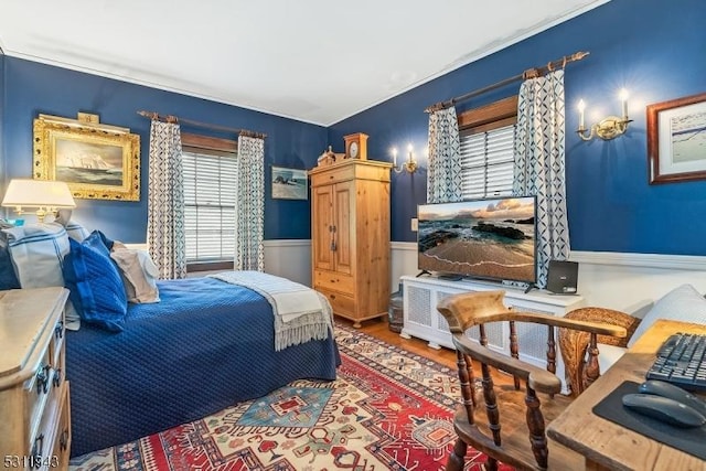 bedroom featuring hardwood / wood-style flooring and multiple windows