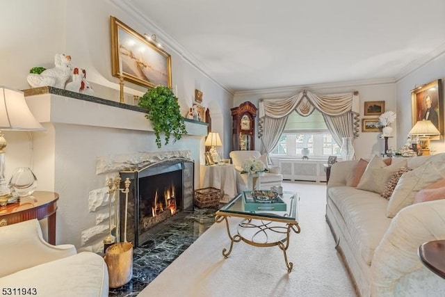 living room featuring ornamental molding, carpet flooring, and a high end fireplace